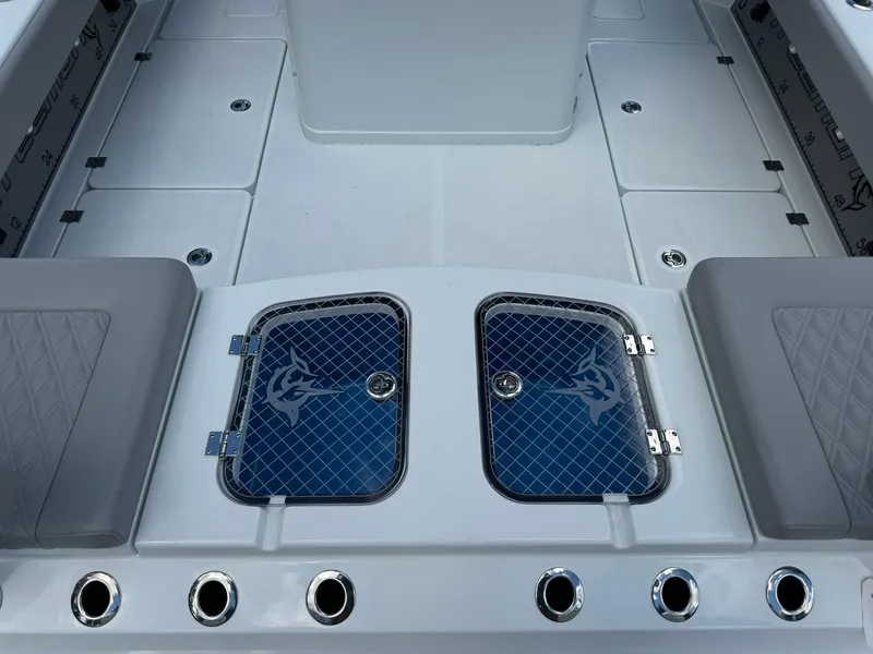 Slide: The Image of 2024 Freeman 28 boat deck with storage compartments and rod holders. - 18