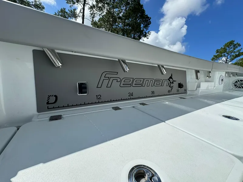 Slide: The Image of Freeman 28 boat deck, 2024 model, with measurement markings and logo under a blue sky. - 20