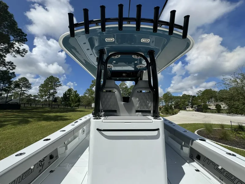 Slide: The Image of 2024 Freeman 28 boat with sleek design and spacious deck under a clear blue sky. - 21