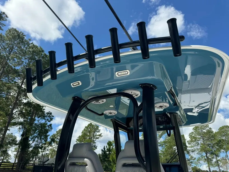 Slide: The Image of Freeman 28 boat, 2024 model, featuring a sleek T-top with rod holders against a blue sky. - 22