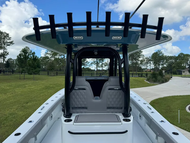 Slide: The Image of 2024 Freeman 28 boat interior with seating and rod holders, set against a scenic outdoor backdrop. - 23