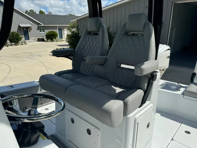 Slide: The Image of 2024 Freeman 28 boat interior with dual gray captain seats and steering wheel. - 24