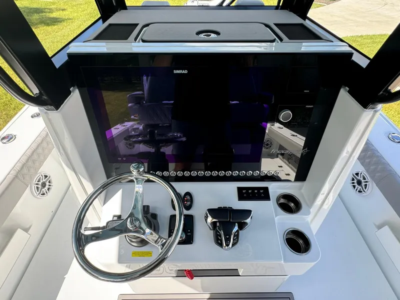 Slide: The Image of 2024 Freeman 28 boat dashboard with steering wheel and control panel. - 27