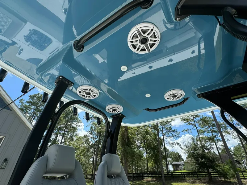 Slide: The Image of 2024 Freeman 28 boat interior with blue ceiling and built-in speakers. - 28