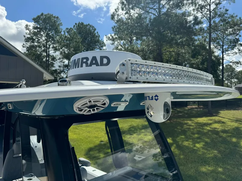 Slide: The Image of 2024 Freeman 28 boat with radar and LED light bar, surrounded by trees. - 37