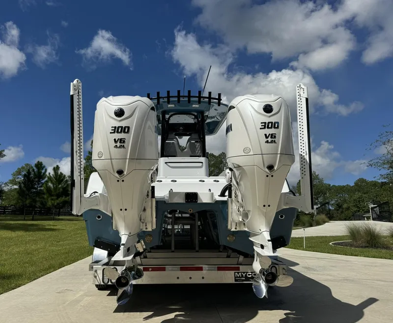 Slide: The Image of Freeman 28 boat with twin 300 V6 engines, 2024 model, parked outdoors. - 4
