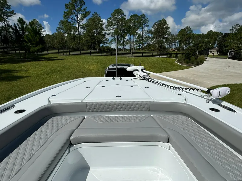 Slide: The Image of 2024 Freeman 28 boat with sleek deck design in a scenic outdoor setting. - 45