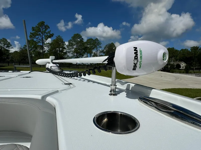 Slide: The Image of Freeman 28 boat deck with trolling motor, 2024 model, under clear blue sky. - 46