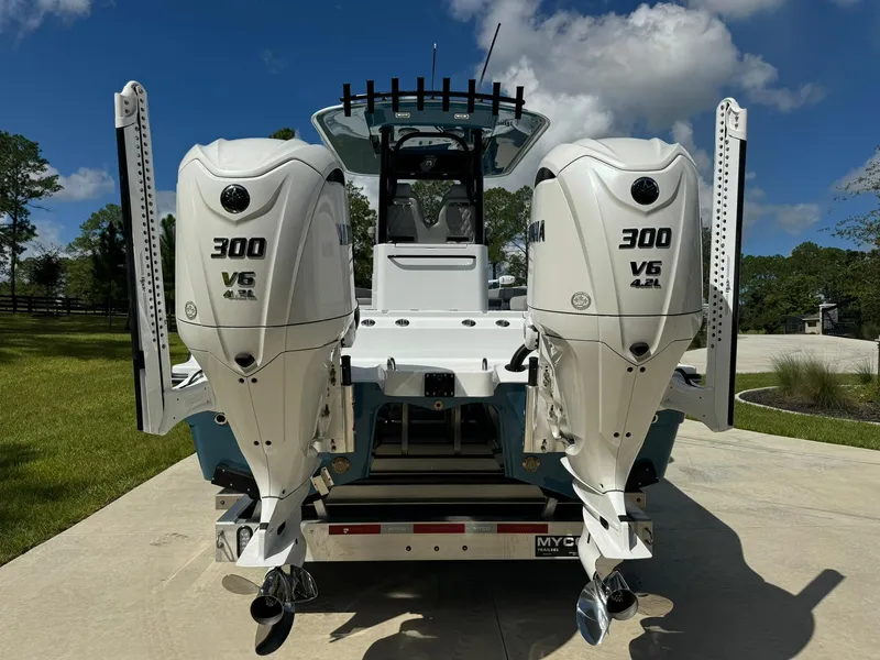 Slide: The Image of 2024 Freeman 28 boat with dual 300 V6 engines, parked outdoors. - 5