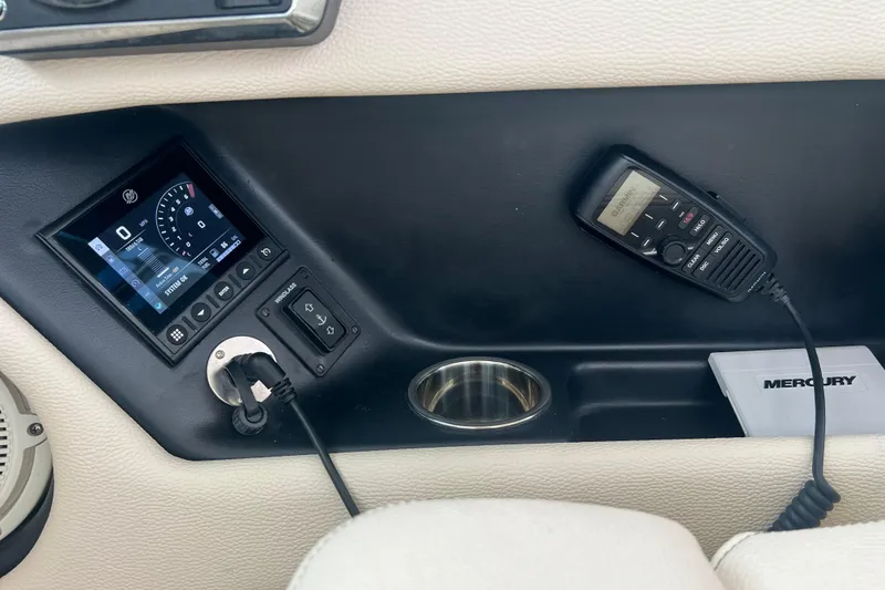 Slide: The Image of 2024 Chris-Craft Calypso 24 dashboard with control panel and Mercury equipment. - 16