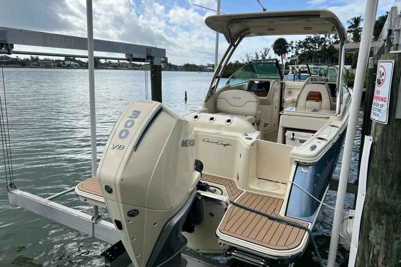 Slide: The Image of 2024 Chris-Craft Calypso 24 boat with Mercury 300 V8 engine docked by the water. - 3