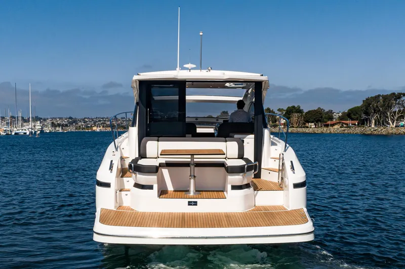Slide: The Image of 2024 Bavaria SR41 yacht on water, rear view, showcasing deck and seating area. - 25