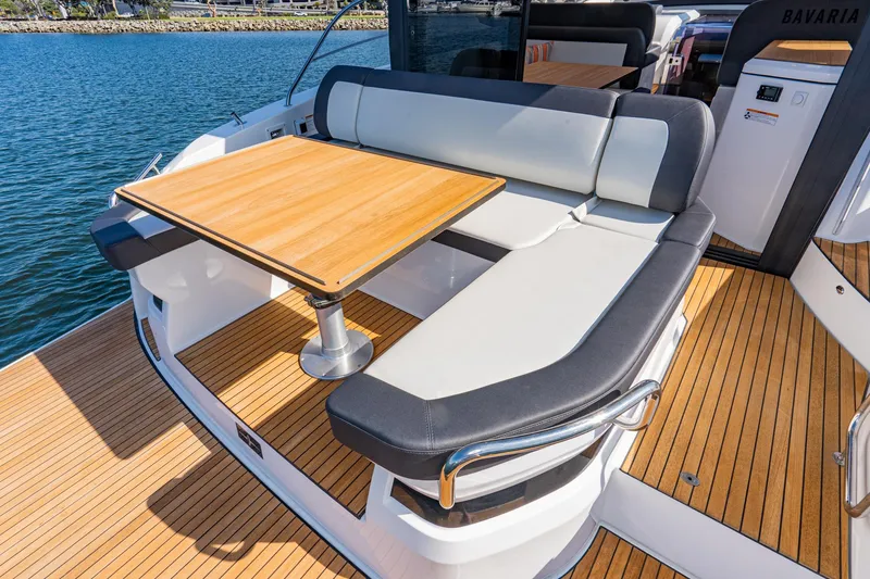 Slide: The Image of 2024 Bavaria SR41 yacht with elegant deck seating and wooden table. - 32