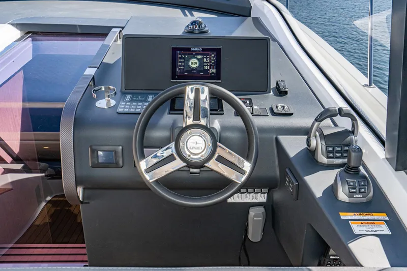 Slide: The Image of 2024 Bavaria SR41 yacht helm with modern controls and navigation display. - 49