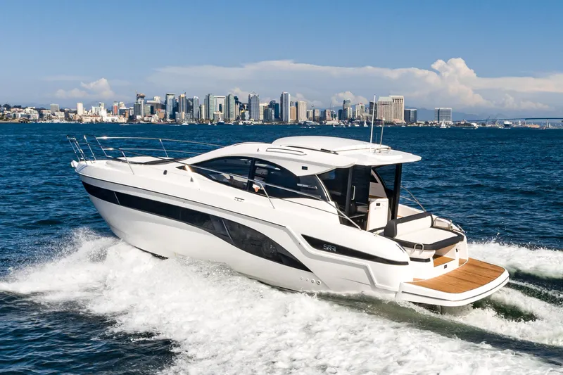 Slide: The Image of 2024 Bavaria SR41 yacht cruising on open water with city skyline in background. - 9