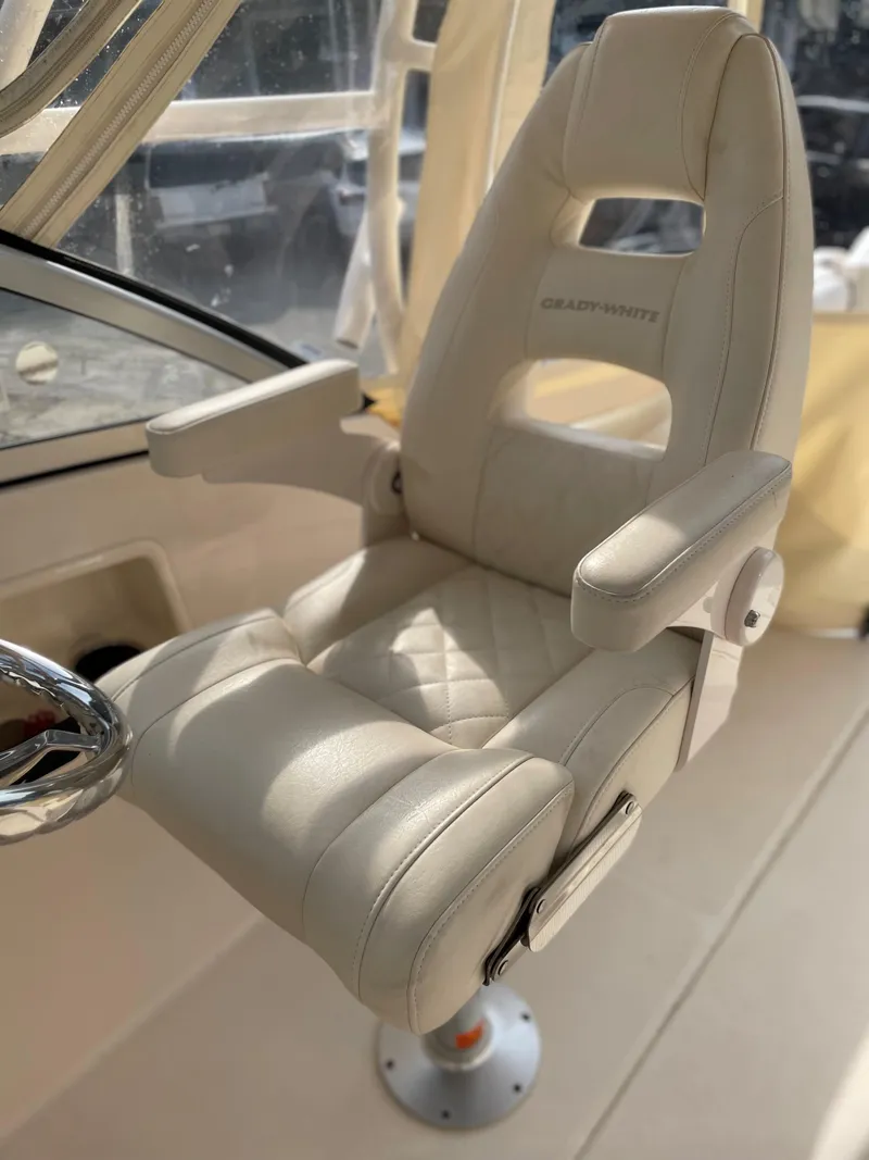Slide: The Image of Luxury captain's chair on 2019 Grady-White 235 Freedom boat, featuring plush beige upholstery. - 5