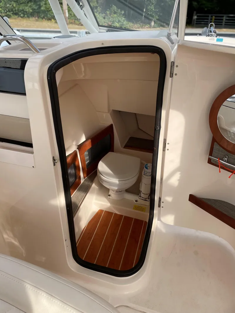 Slide: The Image of 2019 Grady-White 235 Freedom boat interior with compact marine toilet. - 6