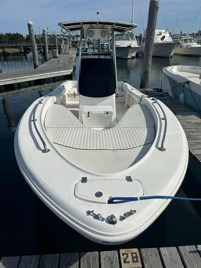 Slide: The Image of 2007 Pioneer 220 Bay Sport boat docked at marina, featuring spacious deck and sleek design. - 2