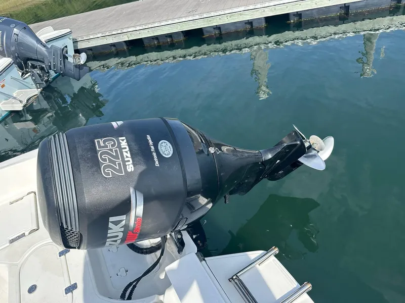 Slide: The Image of Outboard motor on 2007 Pioneer 220 Bay Sport boat, docked by water. - 4