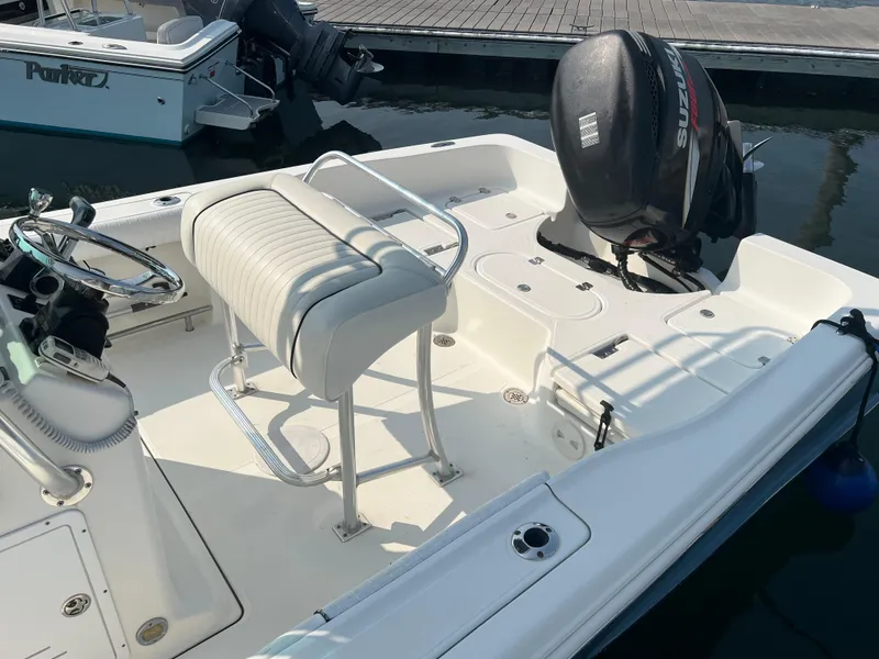 Slide: The Image of 2007 Pioneer 220 Bay Sport boat with outboard motor docked at marina. - 5