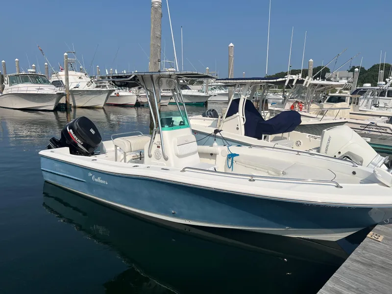 Slide: The Image of 2007 Pioneer 220 Bay Sport boat docked at marina, clear blue sky. - 8