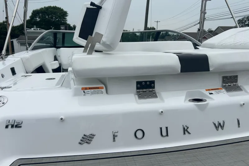 Slide: The Image of 2025 Four Winns H2 OB boat with white seating and sleek design. - 20
