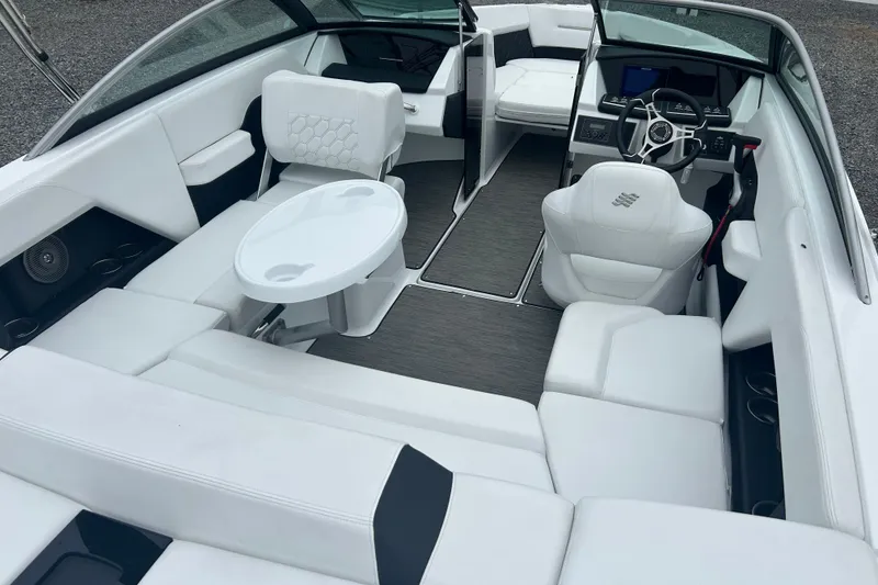 Slide: The Image of 2025 Four Winns H2 OB boat interior with white seating and modern dashboard. - 8