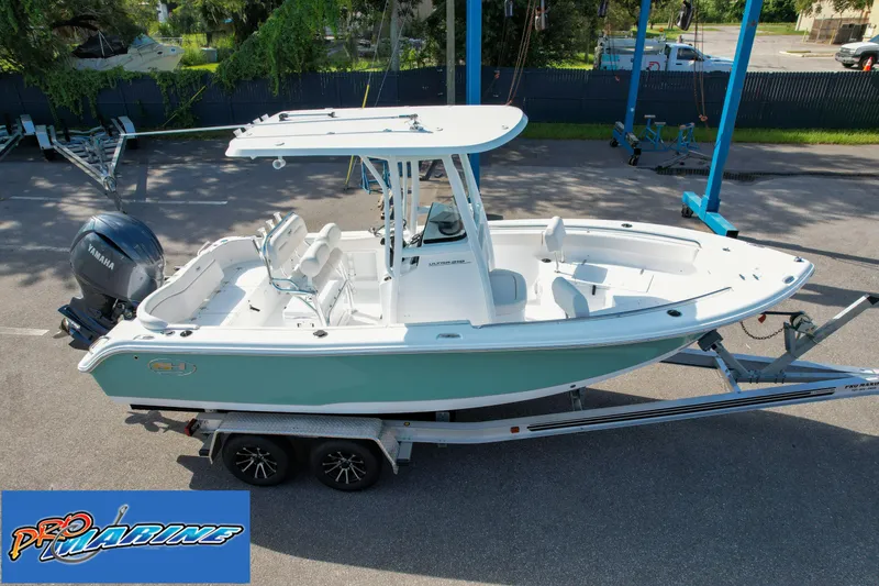 Slide: The Image of 2025 Sea Hunt Ultra 219 boat on trailer, displayed at Pro Marine dealership. - 11