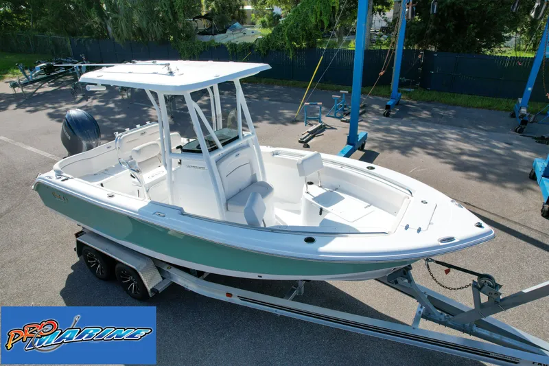 Slide: The Image of 2025 Sea Hunt Ultra 219 boat on trailer at Pro Marine dealership. - 13