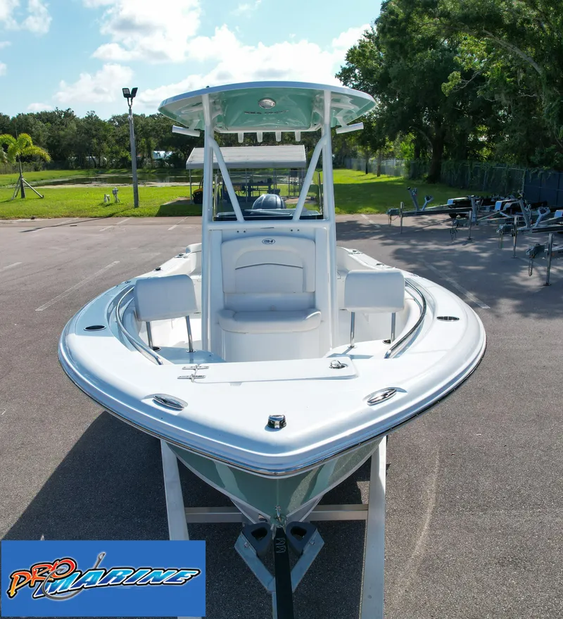 Slide: The Image of 2025 Sea Hunt Ultra 219 boat displayed outdoors on a sunny day. - 15