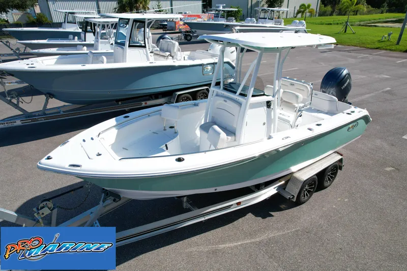 Slide: The Image of 2025 Sea Hunt Ultra 219 boat on trailer in marina parking lot. - 2