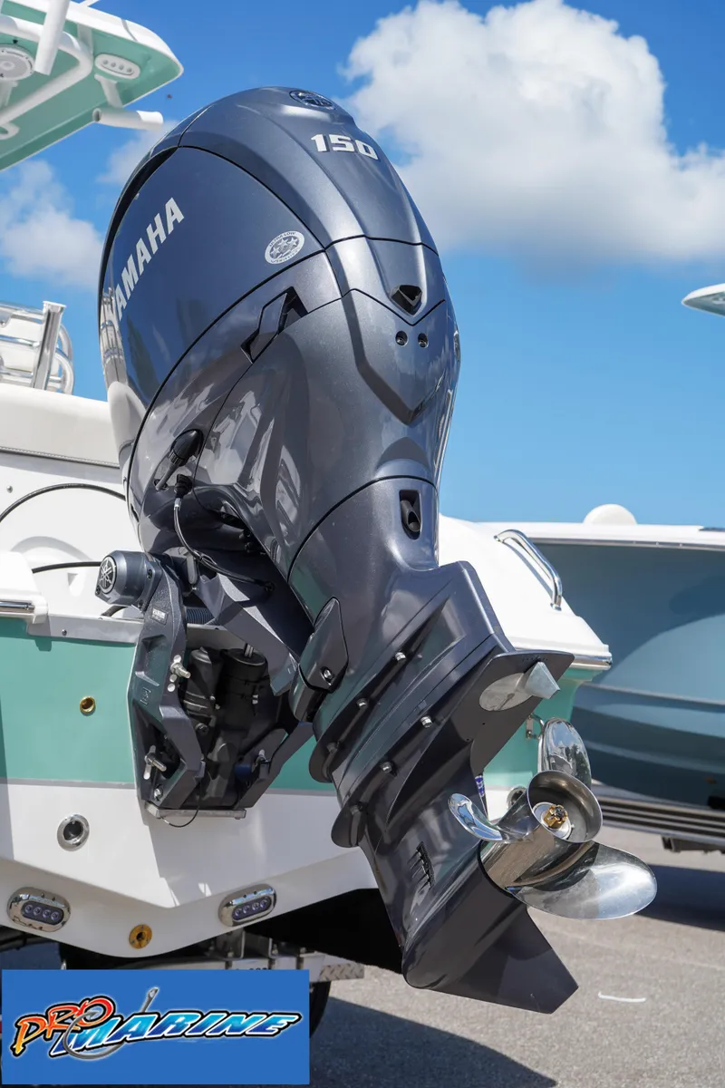 Slide: The Image of Yamaha 150 outboard motor on 2025 Sea Hunt Ultra 219 boat, clear sky background. - 27