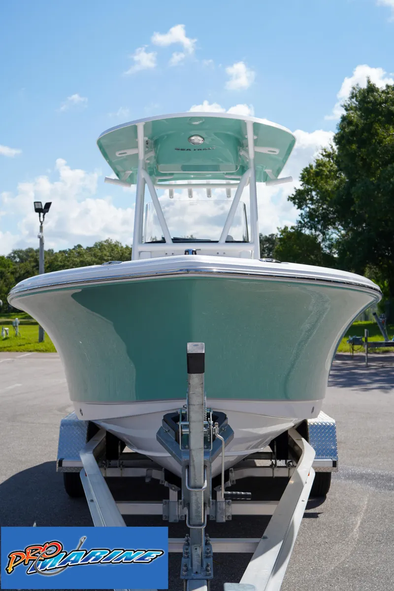 Slide: The Image of 2025 Sea Hunt Ultra 219 boat on trailer, front view, sunny day. - 33