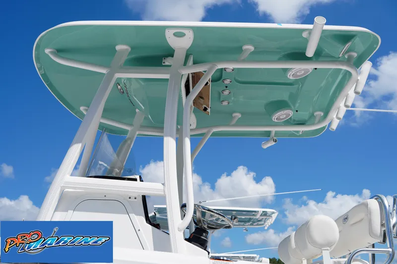 Slide: The Image of Sea Hunt Ultra 219 boat, 2025 model, with teal canopy against blue sky. - 35