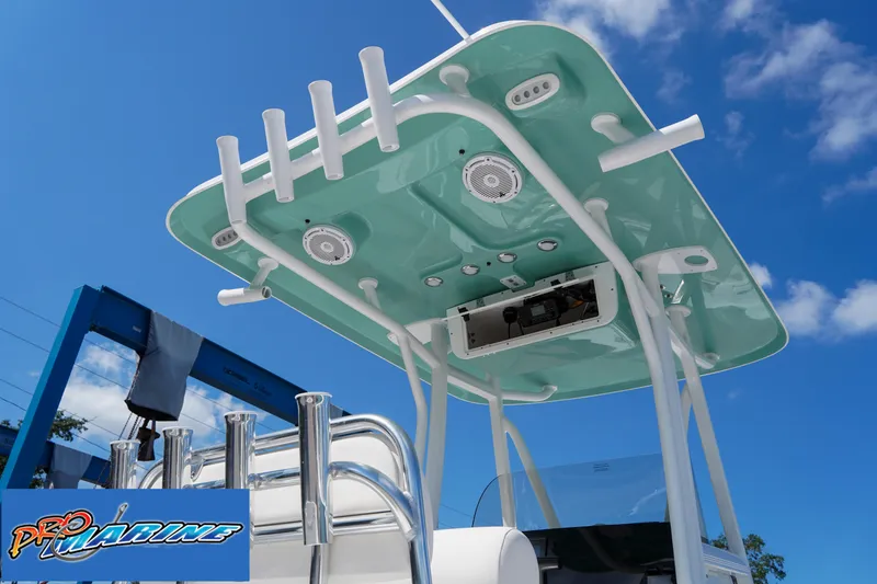 Slide: The Image of 2025 Sea Hunt Ultra 219 boat with teal canopy and rod holders under a blue sky. - 37