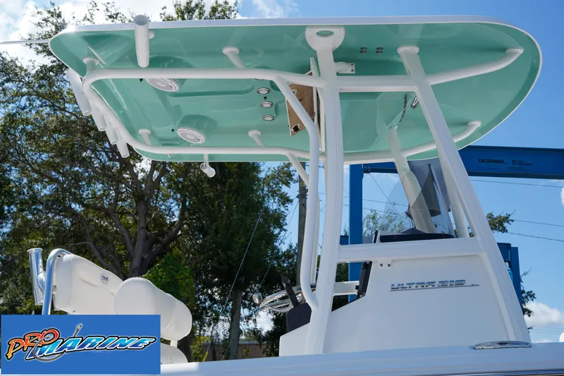 Slide: The Image of 2025 Sea Hunt Ultra 219 boat with teal T-top and Pro Marine logo. - 38