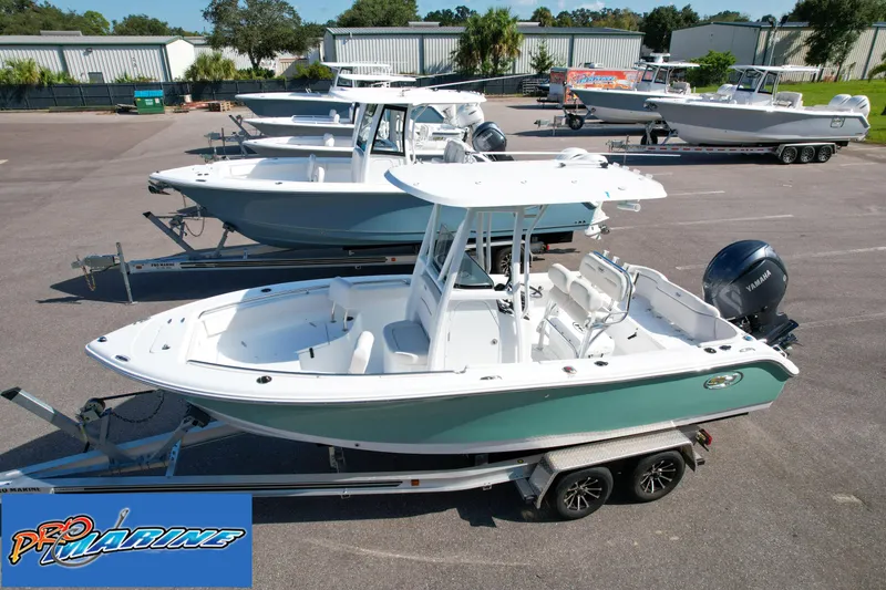 Slide: The Image of 2025 Sea Hunt Ultra 219 boat on trailer in marina lot. - 4