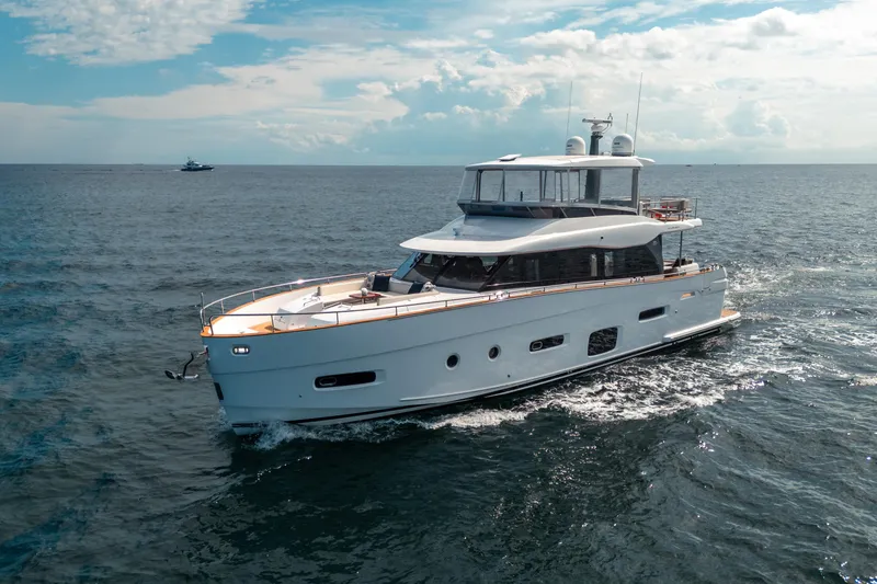 Slide: The Image of 2018 Azimut Magellano 66 yacht cruising on open sea under a partly cloudy sky. - 0