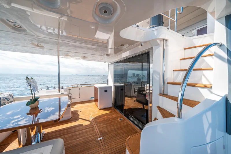Slide: The Image of Luxurious 2018 Azimut Magellano 66 yacht deck with elegant wood flooring and ocean view. - 11