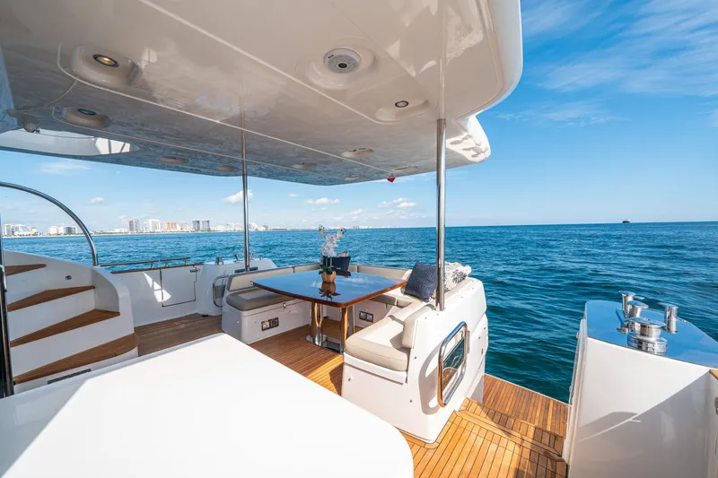 Slide: The Image of Luxurious 2018 Azimut Magellano 66 yacht deck with ocean view and elegant seating area. - 12