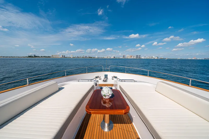 Slide: The Image of Azimut Magellano 66 yacht deck with seating, ocean view, and city skyline. - 16
