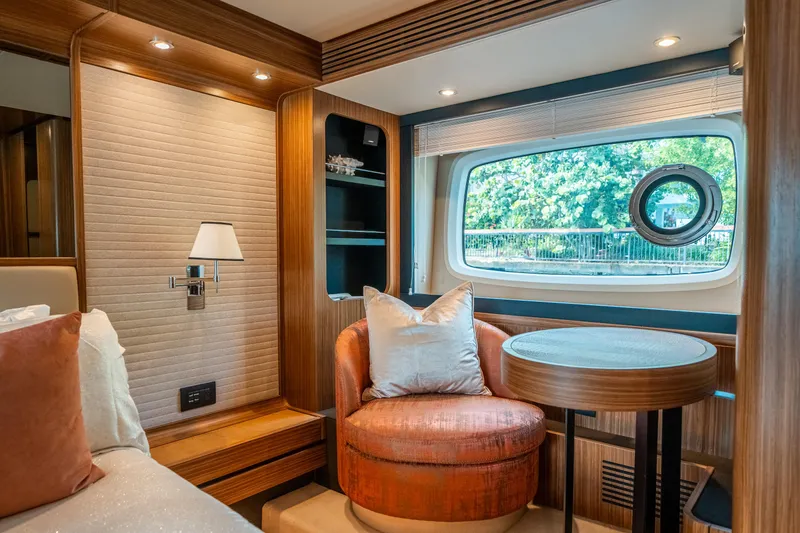 Slide: The Image of Luxurious interior of 2018 Azimut Magellano 66 yacht with elegant seating and window view. - 32