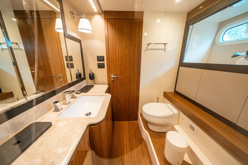 Slide: The Image of Luxurious bathroom in 2018 Azimut Magellano 66 yacht with modern fixtures and wood accents. - 35