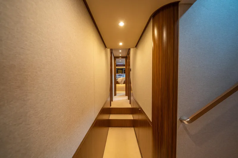 Slide: The Image of Interior hallway of 2018 Azimut Magellano 66 yacht, featuring elegant wood paneling. - 37