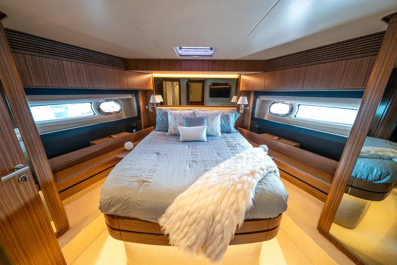 Slide: The Image of Luxurious bedroom interior of 2018 Azimut Magellano 66 yacht with elegant wood paneling. - 38