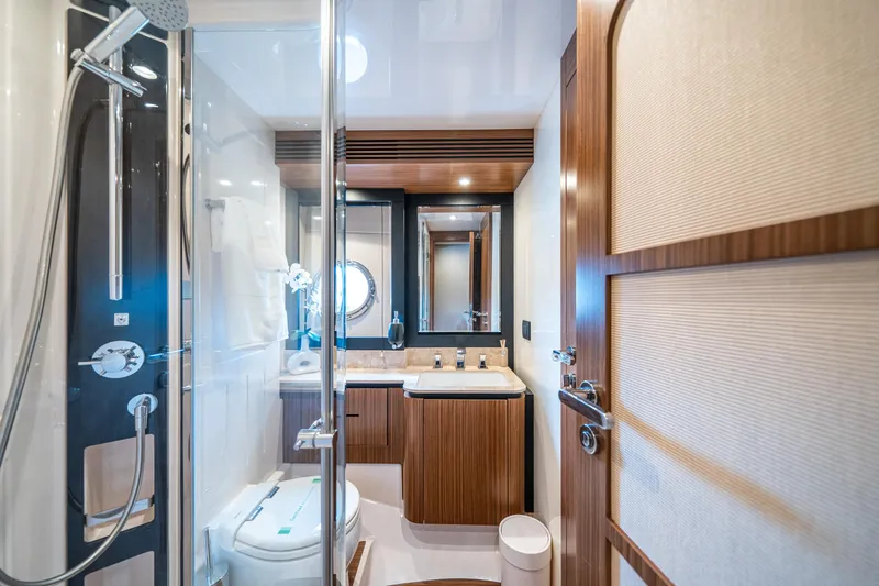 Slide: The Image of Luxurious bathroom in 2018 Azimut Magellano 66 yacht with modern fixtures and wood accents. - 40