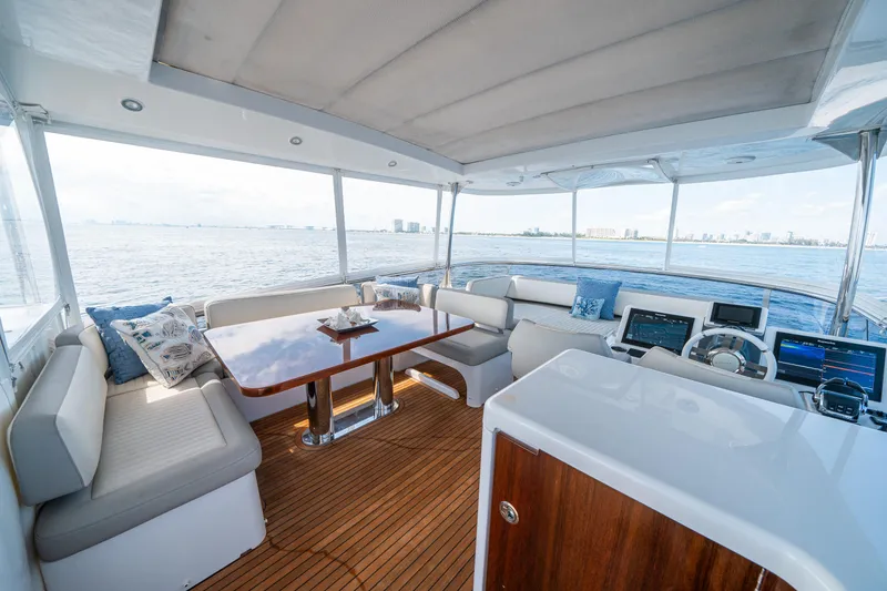 Slide: The Image of Luxurious 2018 Azimut Magellano 66 yacht interior with elegant seating and ocean view. - 48
