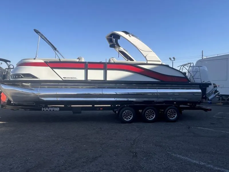 Slide: The Image of 2025 Harris Grand Mariner SL 250 pontoon boat on trailer, featuring sleek design and vibrant accents. - 3