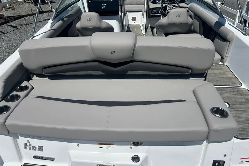 Slide: The Image of 2025 Four Winns HD3 boat interior with gray seating and cup holders. - 10