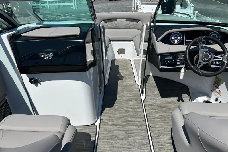 Slide: The Image of 2025 Four Winns HD3 boat interior with modern dashboard and seating. - 13